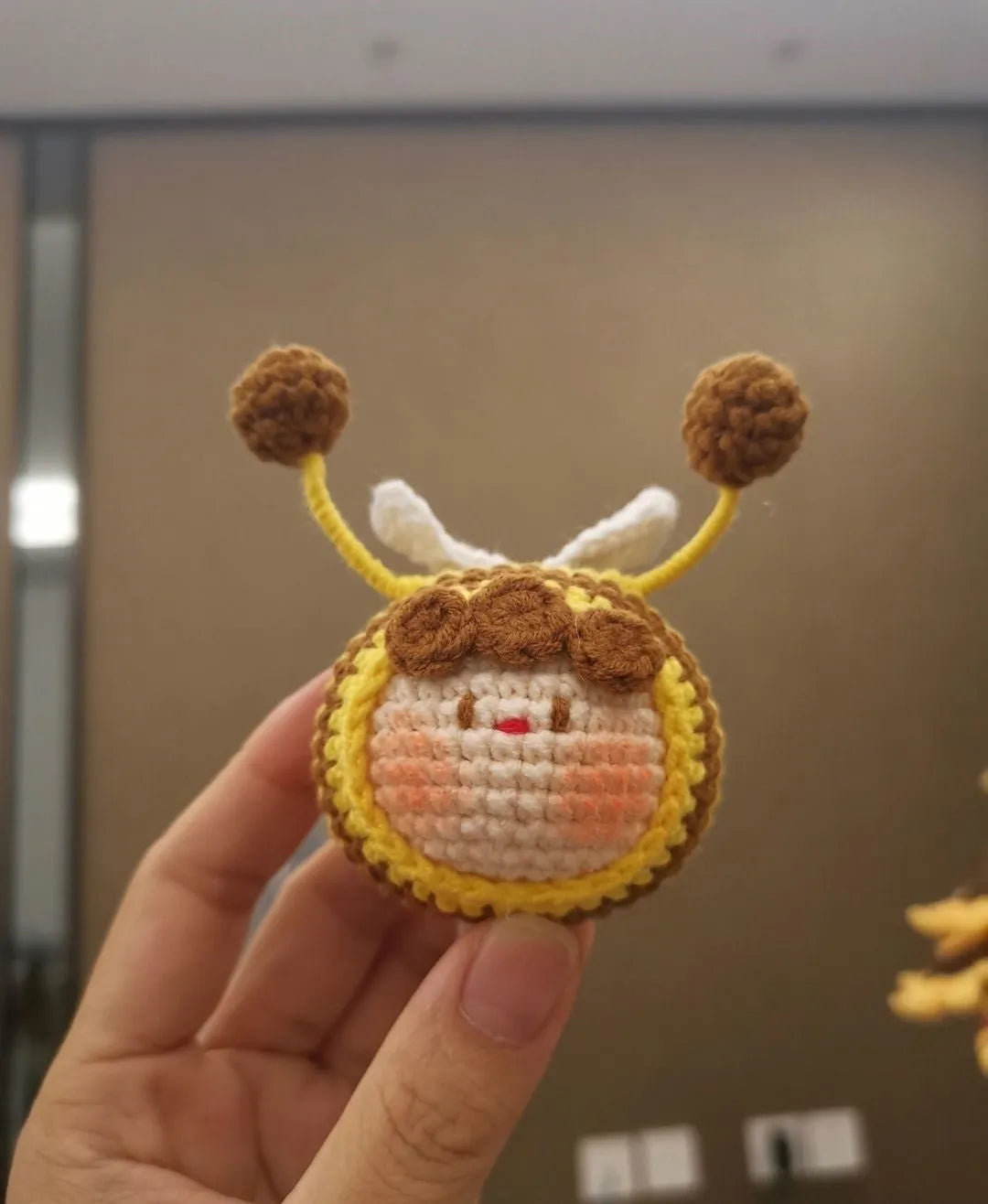 Handmade crocheted bee colony wool doll with bee pendant accessory in plush soft toy construction