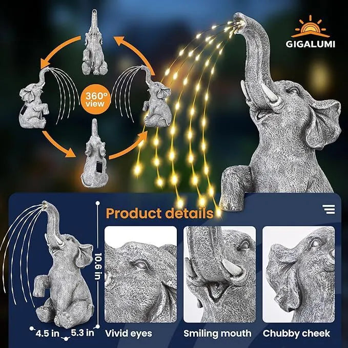 Grey resin elephant garden statue with warm white LED light glowing at its base on a patio.