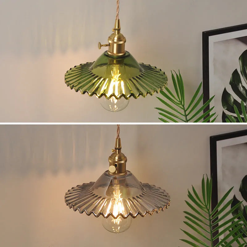 Retro brass wall lamp with a white glass lotus flower shade mounted on a beige wall.