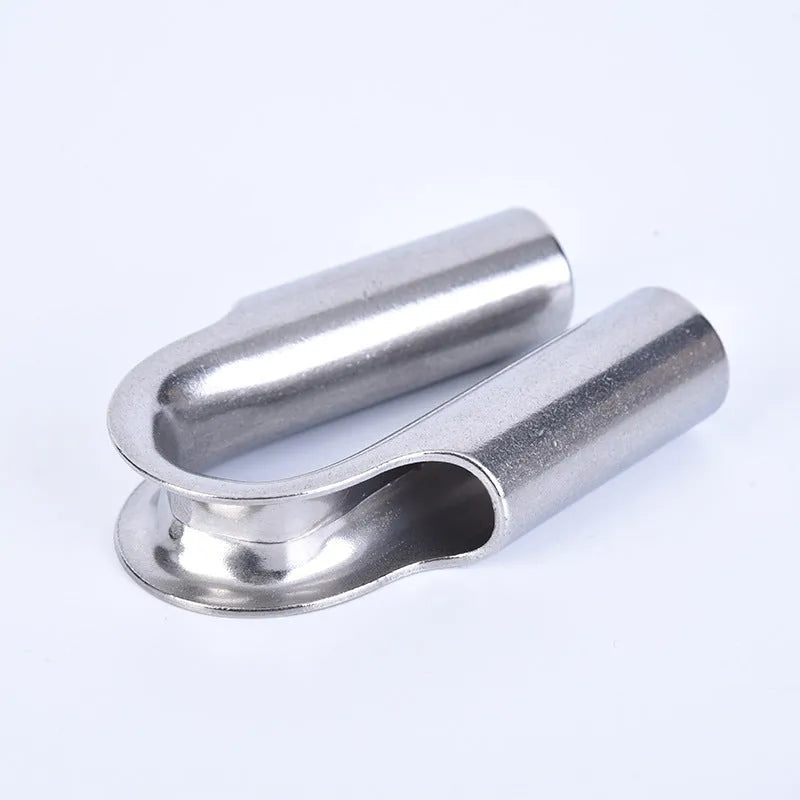 Set of stainless steel tubular chicken heart sleeve rings in various sizes on a workbench.