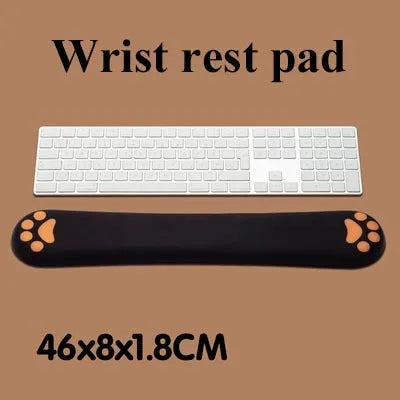 Cat's claw shaped memory foam wrist support pad in black, placed in front of a keyboard.