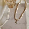 Geometric-shaped alloy necklace on a model, showing its adjustable chain length.