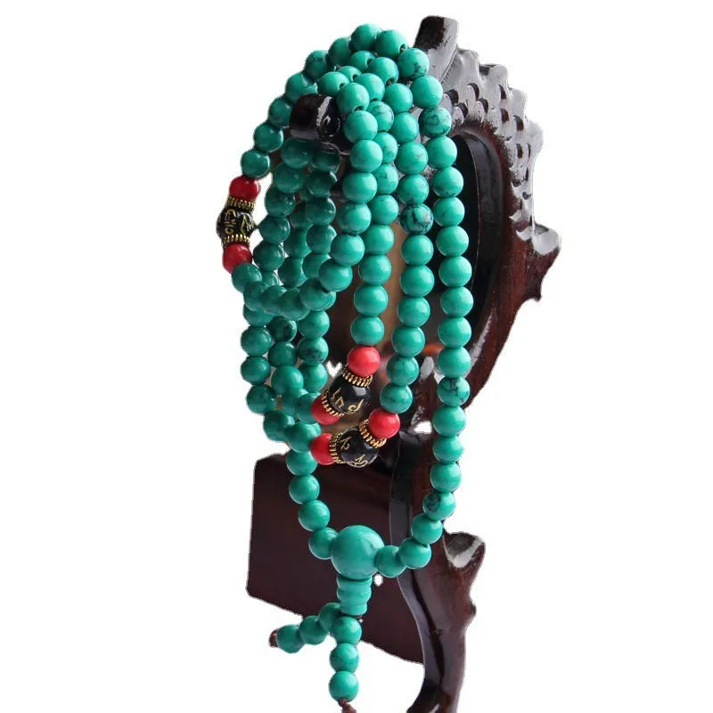 Turquoise Tibetan bracelet with 108 polished synthetic stone beads in 6mm and 8mm sizes