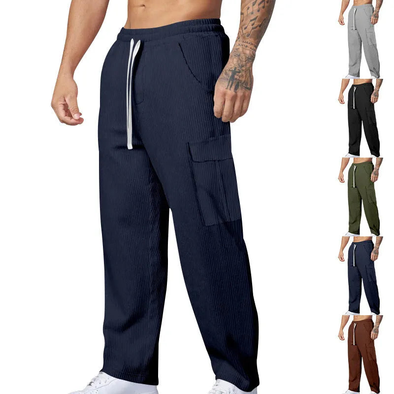 Men's navy blue corduroy cargo trousers with a drawstring waist and straight wide-leg cut on a hanger.