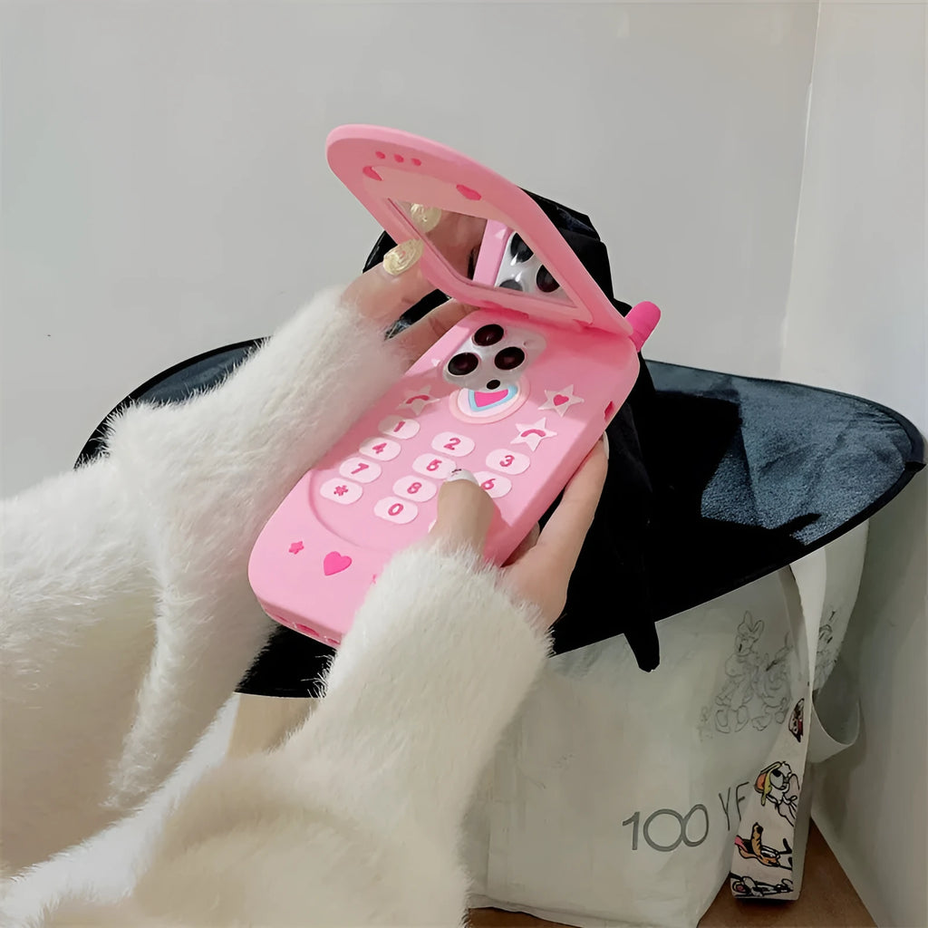 Pink silicone flip phone case with a mirror for iPhone models.