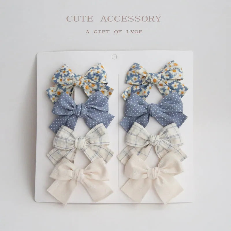 Dovetail bow hairclip set for children in cloth material with eight colour options