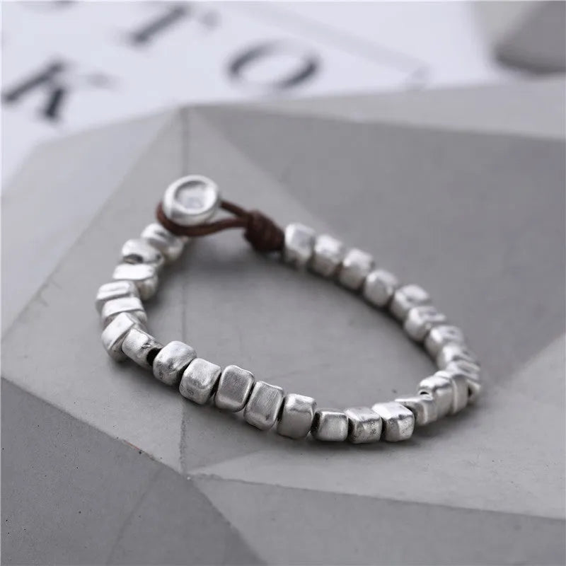 Handmade silver bracelet with irregular square design and wooden elements on 17cm elastic band