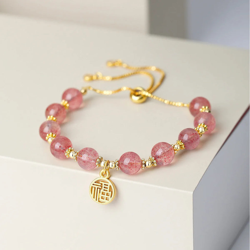Women's Strawberry Quartz crystal bracelet with geometric shape and fu character design on an electroplated chain.