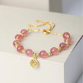 Women's Strawberry Quartz crystal bracelet with geometric shape and fu character design on an electroplated chain.