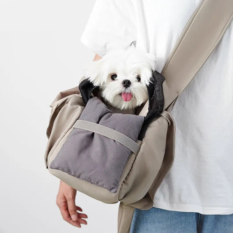 Apricot-colour cloth pet carrier handbag with mesh panels and a shoulder strap.