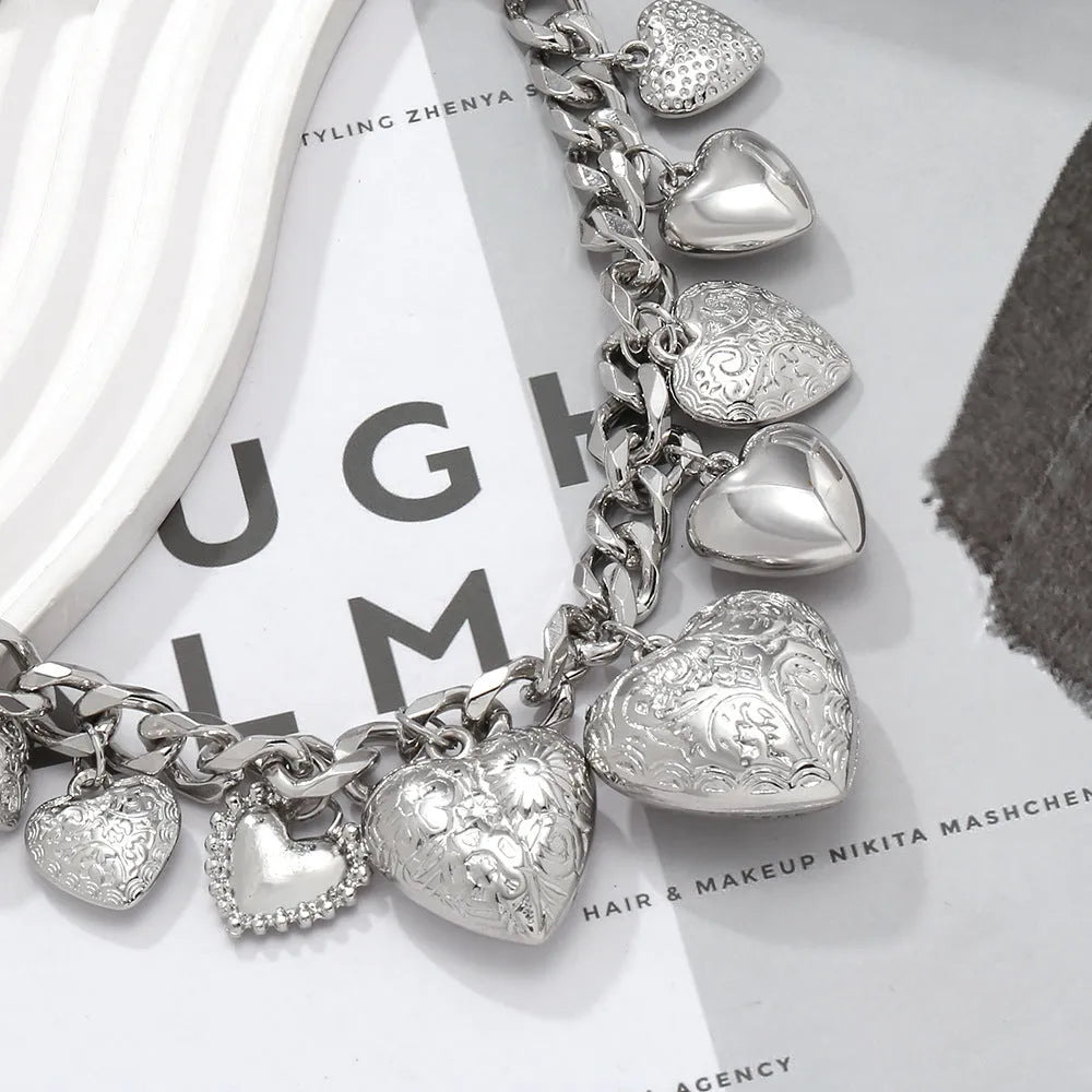 Gold women's necklace with a large, exaggerated heart-shaped pendant on an adjustable chain.