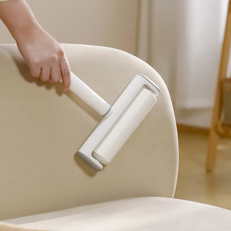 Lint remover roller with plastic handle and tearable paper roll for removing pet hair and dust.