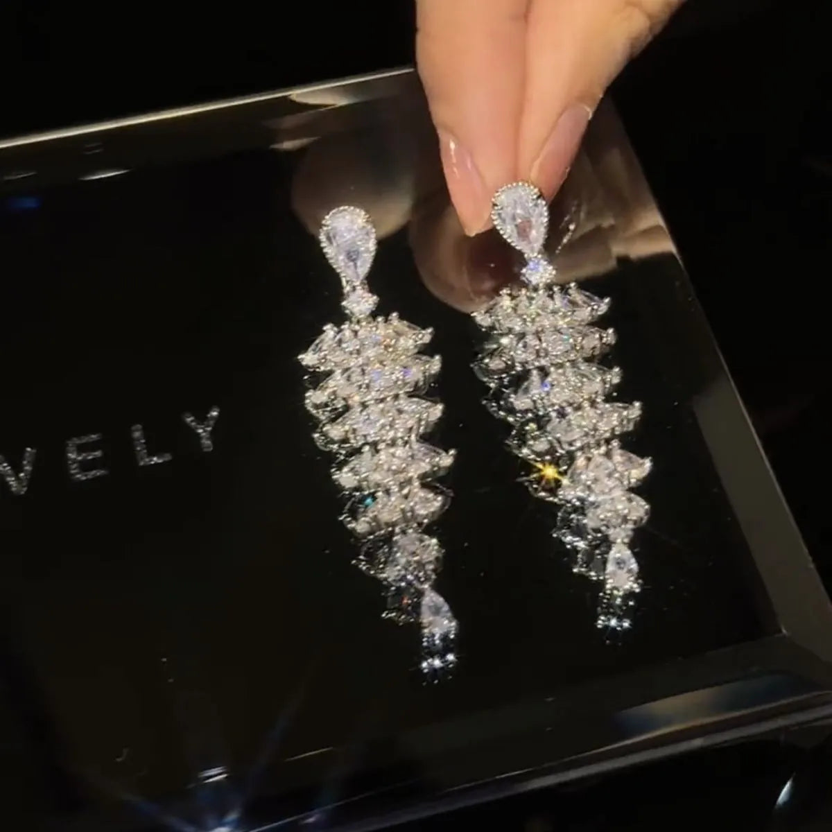 Women's silver pagoda Christmas tree drop earrings with sparkling zircon details on copper.