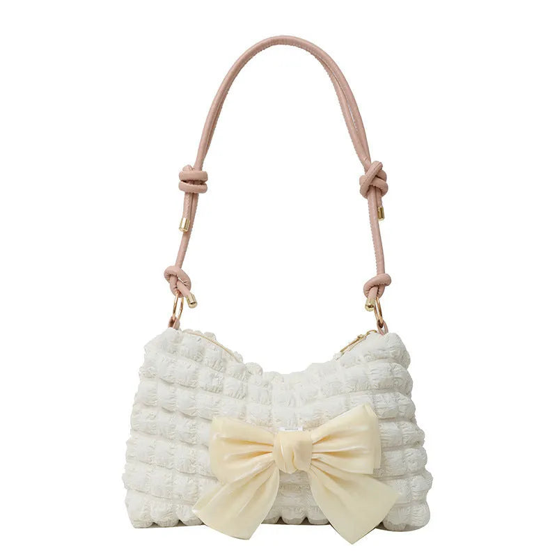 Women's canvas handbag with single shoulder strap showing horizontal square shape and sandwich pocket design