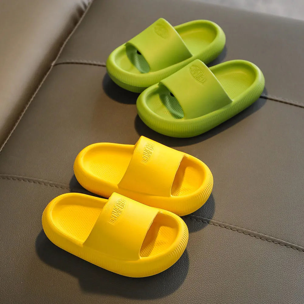 Children's mixed colour EVA slippers with textured sole, shown in blue, green, orange, pink, and yellow.