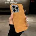 Solid colour suede iPhone case with frosted finish in dark green, shown on an iPhone