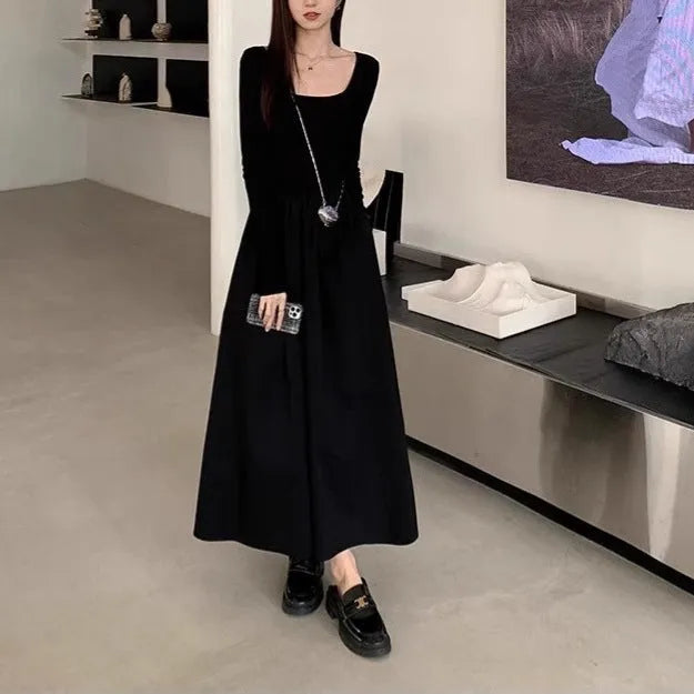 Women's black knitted dress with square collar, long sleeves, and an elastic A-line skirt.