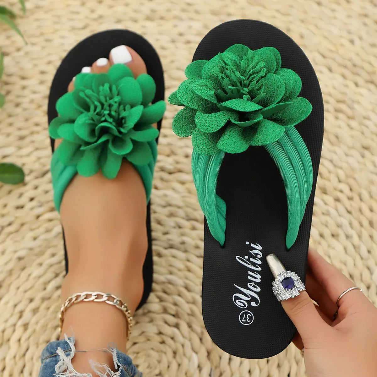 Women's beige flip-flops with a red flower decoration on the strap and a lightweight EVA sole.