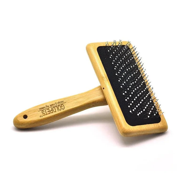 Goldpets bamboo and wood slicker brush for pets with stainless steel pins on a wooden handle.