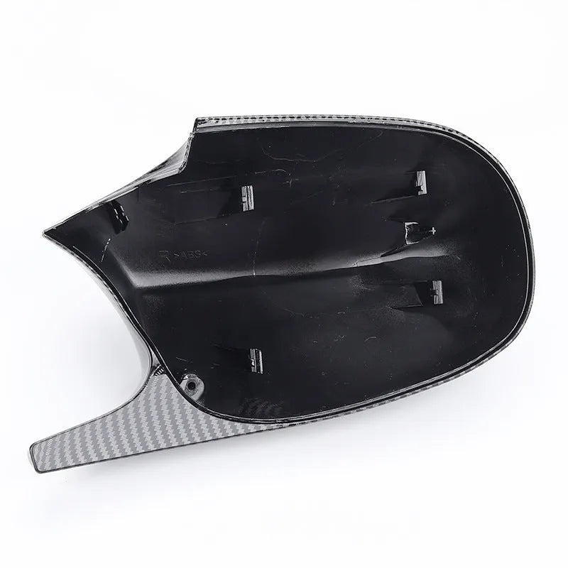 A pair of black ABS plastic rearview mirror shells for a BMW 3 Series E90 car.