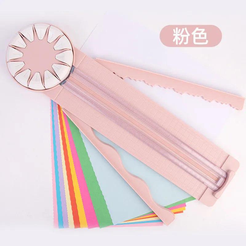 Pink plastic 12-in-1 paper cutting machine with dotted line and other pattern guides on a flat surface.