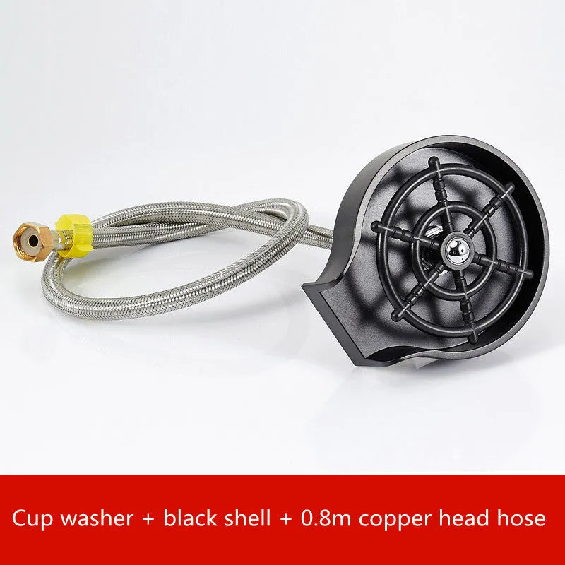 Black automatic cup washer with five-hole nozzle installed on a bar counter sink with a glass being rinsed