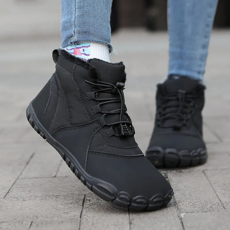 Unisex black waterproof snow boots with lace-up front, fleece lining, and rugged rubber sole on a winter background.