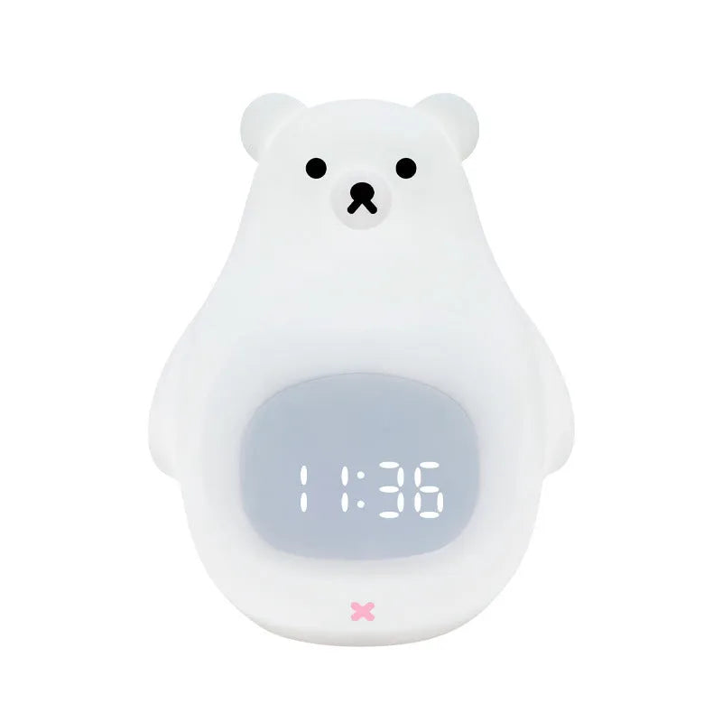 White silicone bear-shaped night light with remote control on a wooden bedside table.