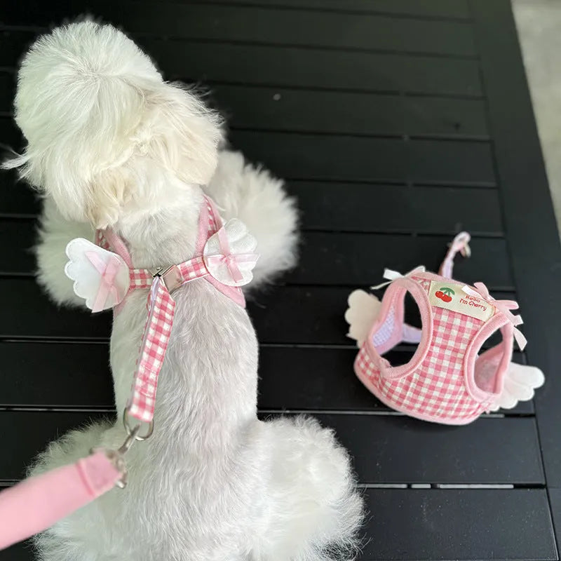 Pink and black cotton chest and back harness with rope leash for a small dog on a white background.