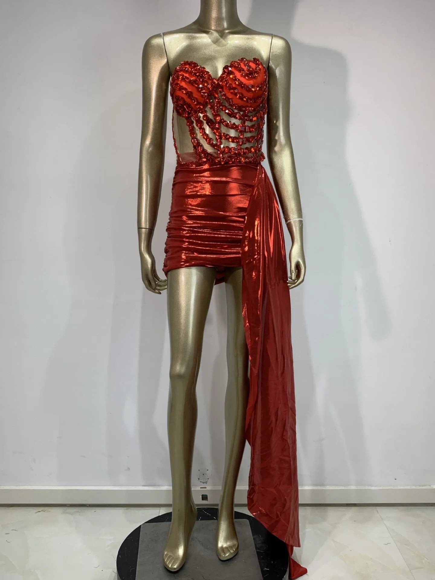 Red two-piece stage costume skirt suit with see-through mesh panels and a form-fitting spandex design.