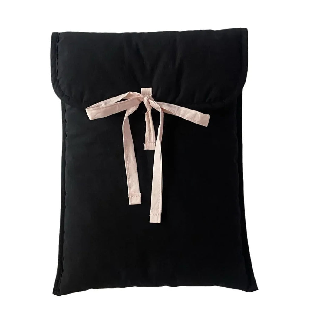 Black and white women's quilted nylon laptop bag with a ballet-style bow.