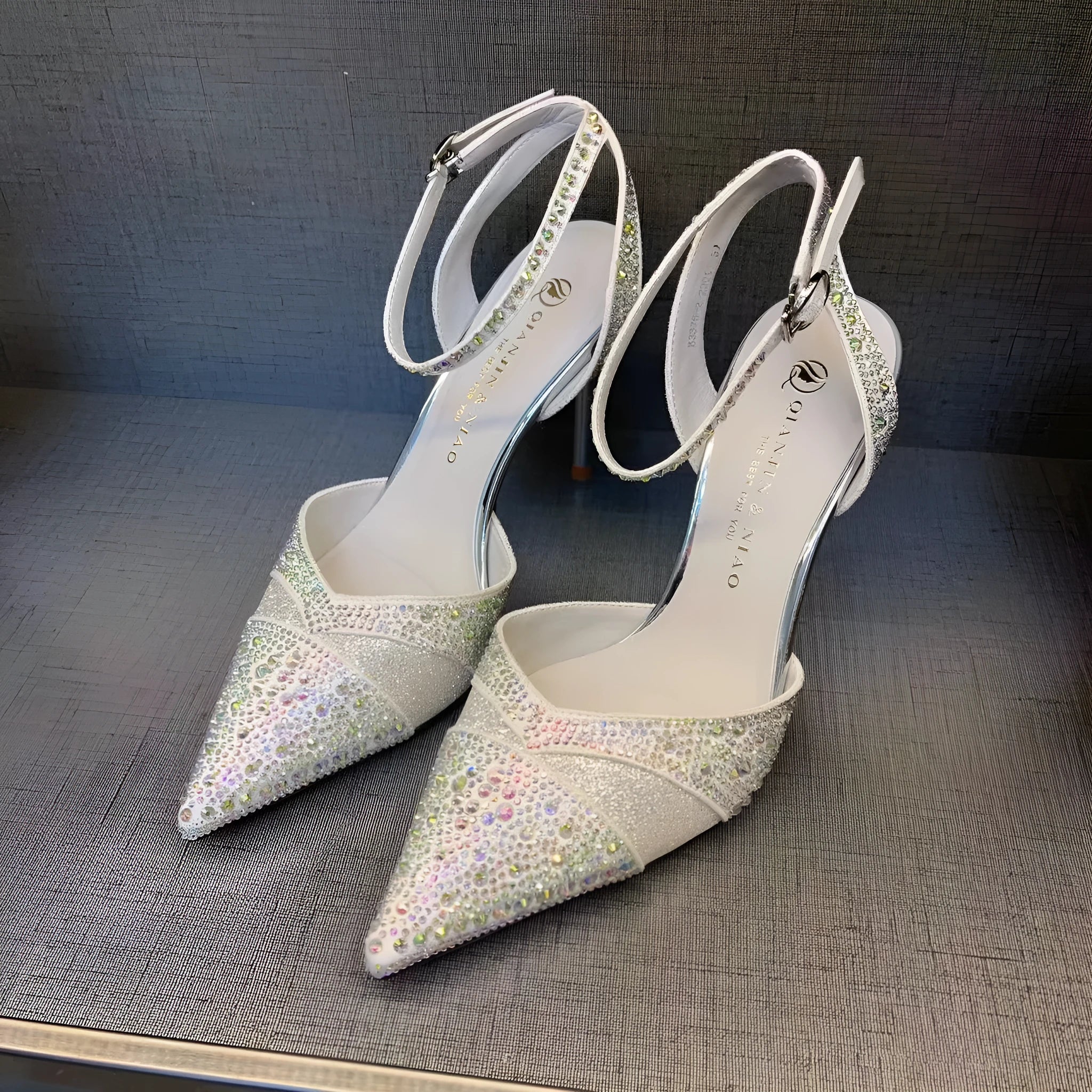 Women's black high heels with hollow red stiletto heel and pointed toe.