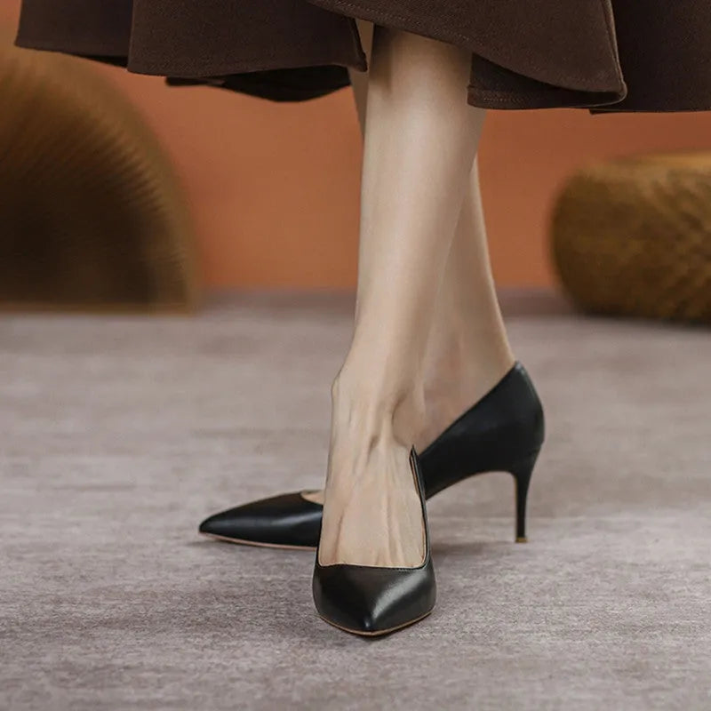 Black pointed toe high heel shoes with stiletto heel on white background