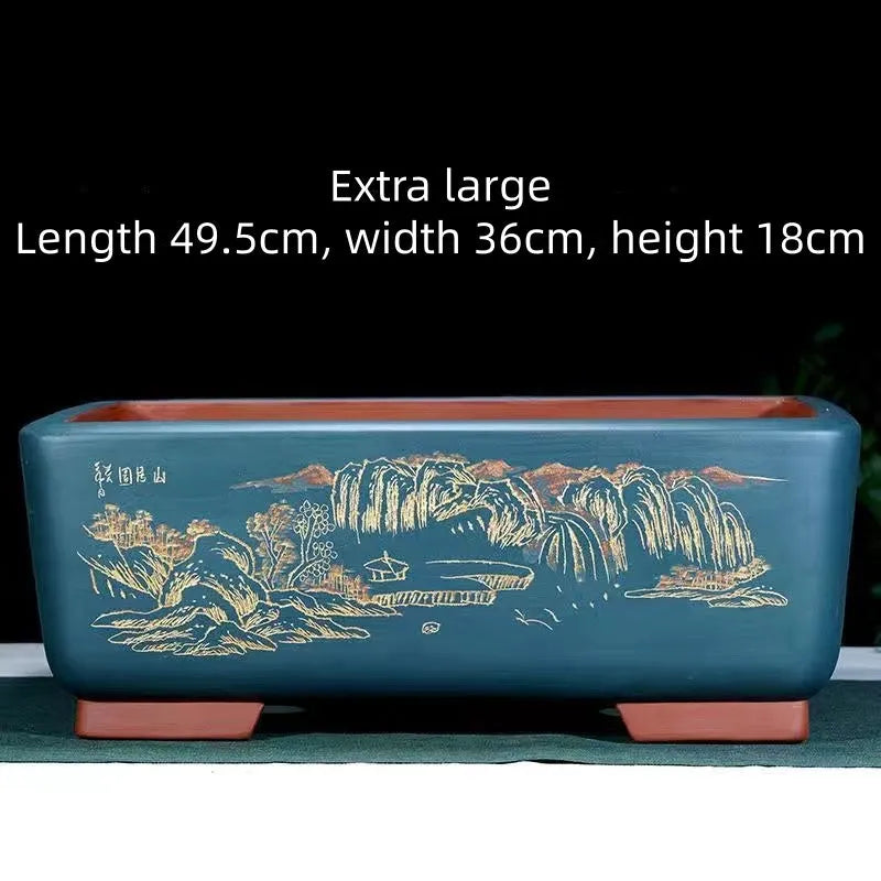 Handmade deep blue black rectangle purple clay bonsai pot on a wooden surface.