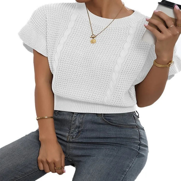 White twisted string knitted pullover sweater with ruffled short sleeves on a hanger.