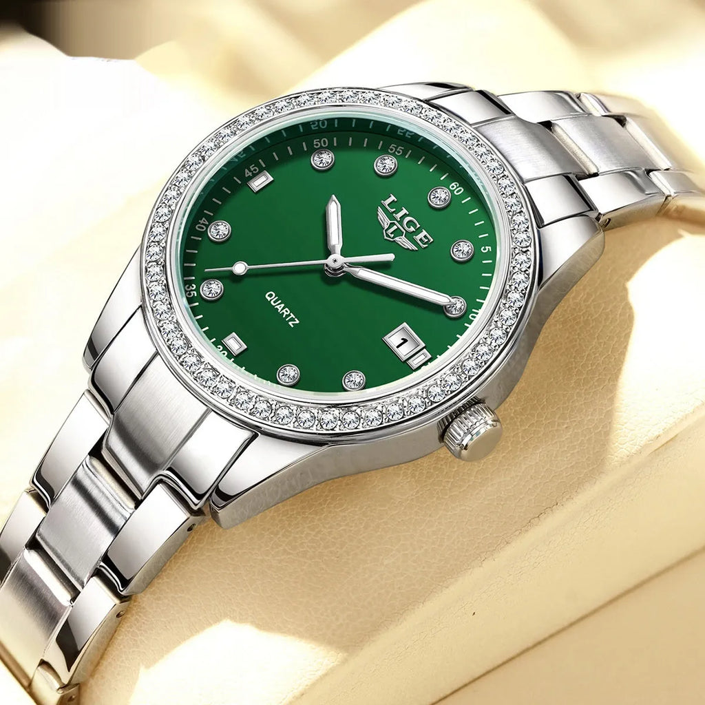 Silver stainless steel women's watch with diamond-encrusted bezel and luminous hands on a 34mm round dial.