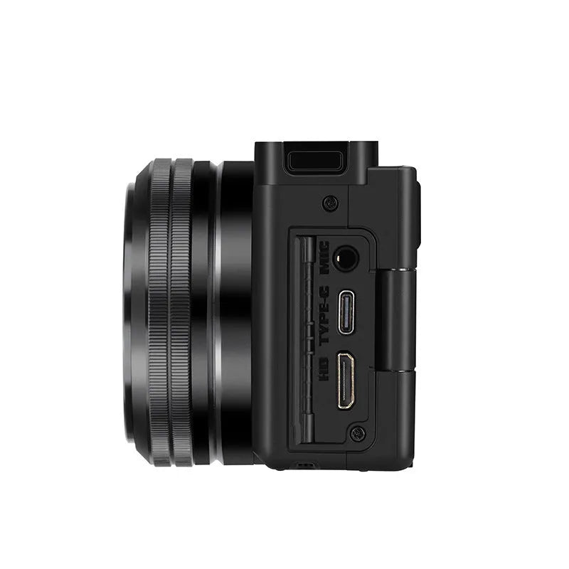 Compact digital camera in black with ultra-wide-angle lens, touch screen, and sling on a white background