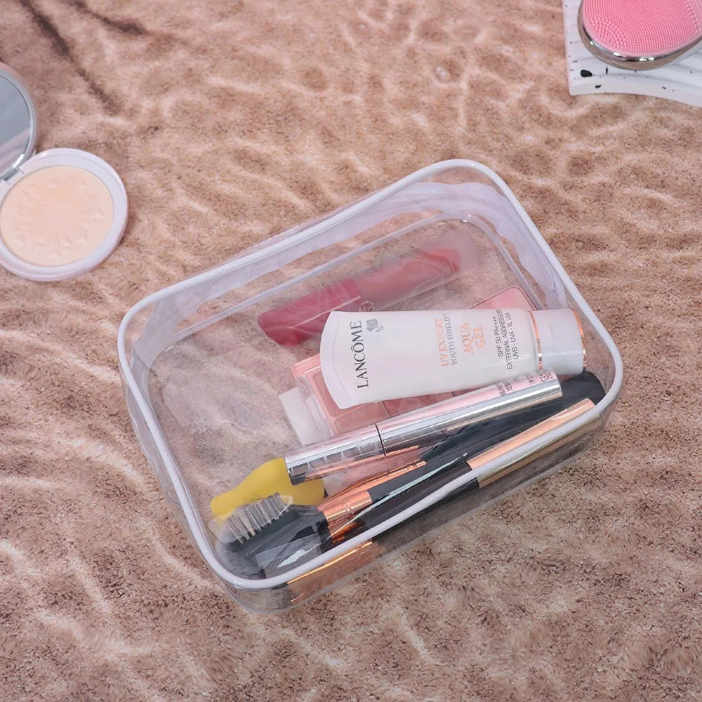 PVC transparent makeup bag in semi-transparent black, pink and white colours with zip closure