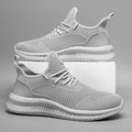 Black low-cut safety work shoe with a steel toe cap on a grey background.