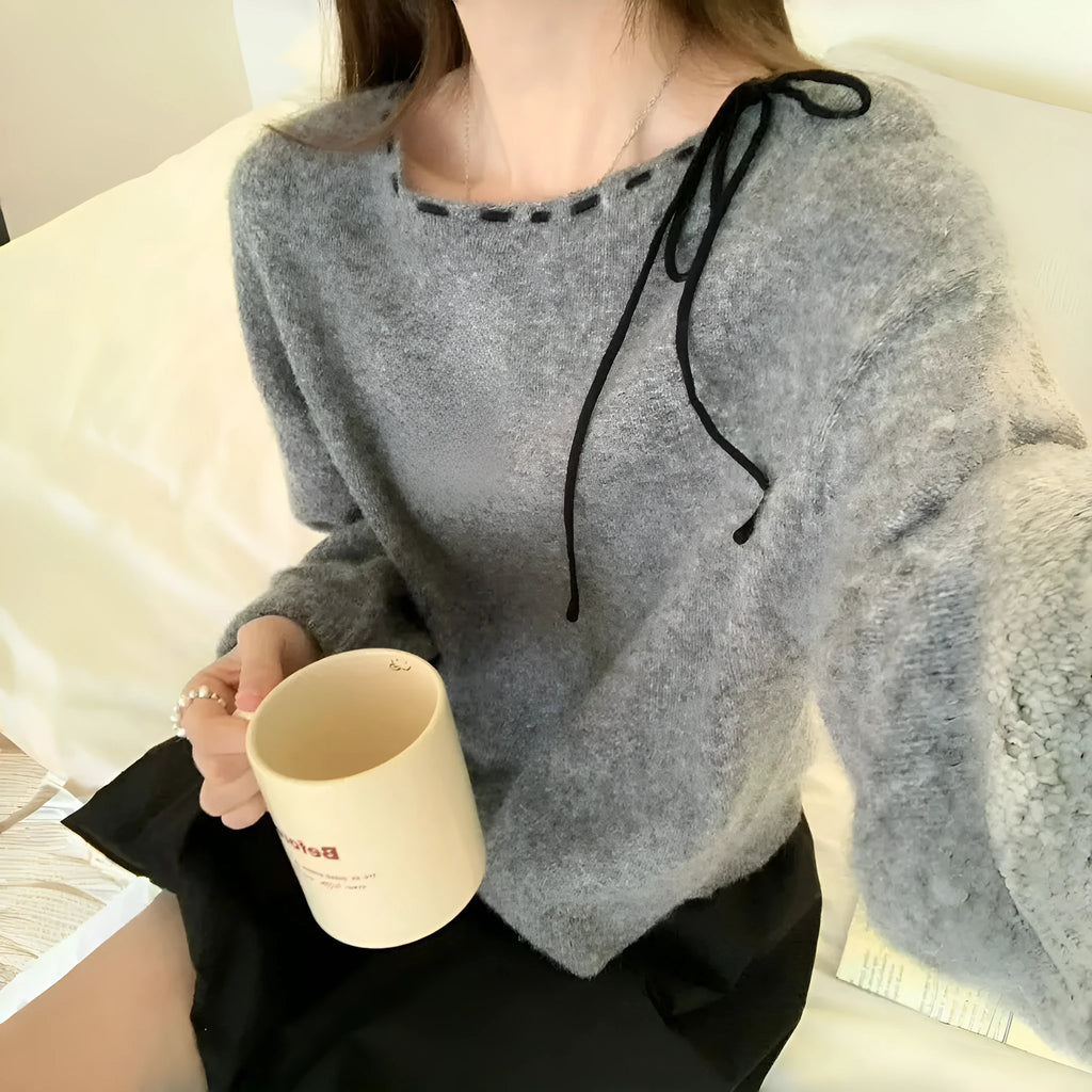 Grey loose-fitting women's pullover jumper on a hanger.
