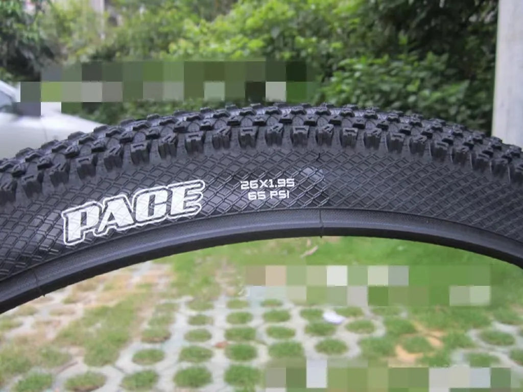 Mountain bike tyre with tread, shown in multiple size options: 26, 27.5 and 29 inch diameters.