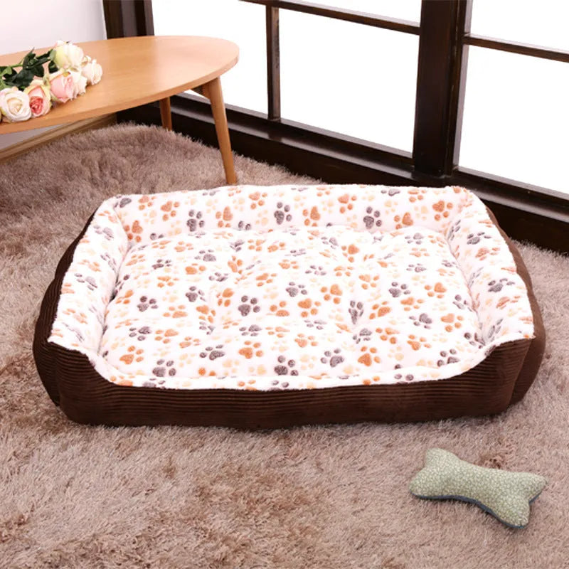 Beige sofa-style dog bed with plush fabric and raised bolsters for small dogs
