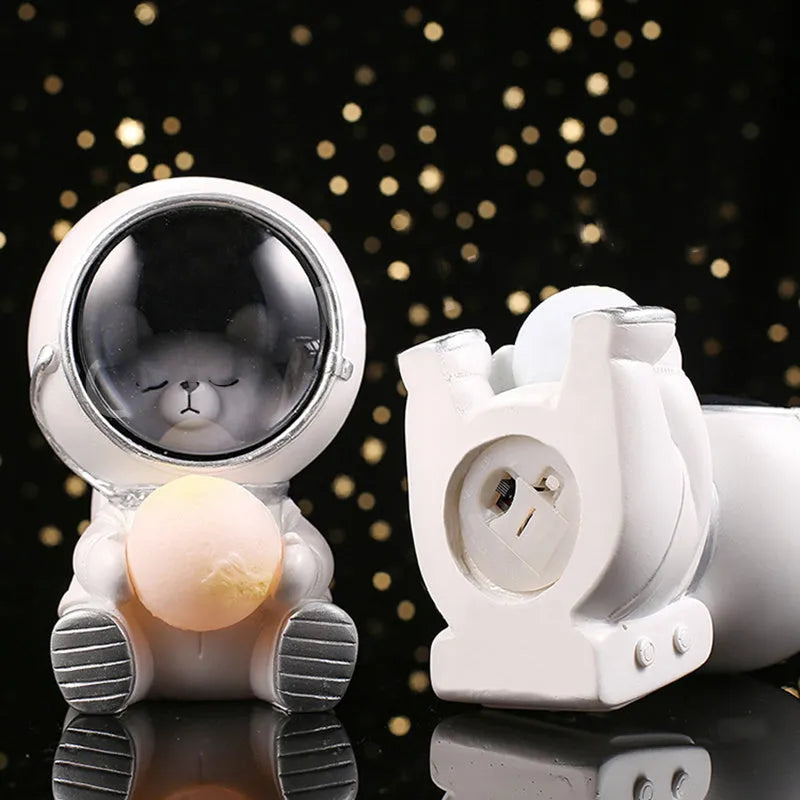 Resin bear-shaped starry sky night light with soft LED glow on a wooden table.