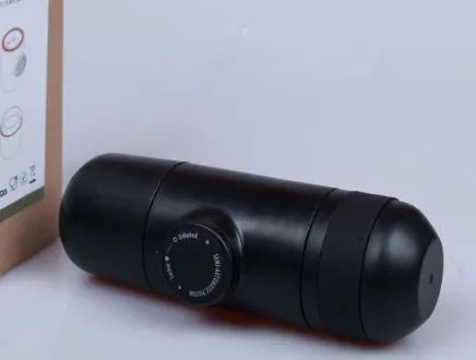 Black portable manual coffee machine measuring 6cm by 17.5cm on a table