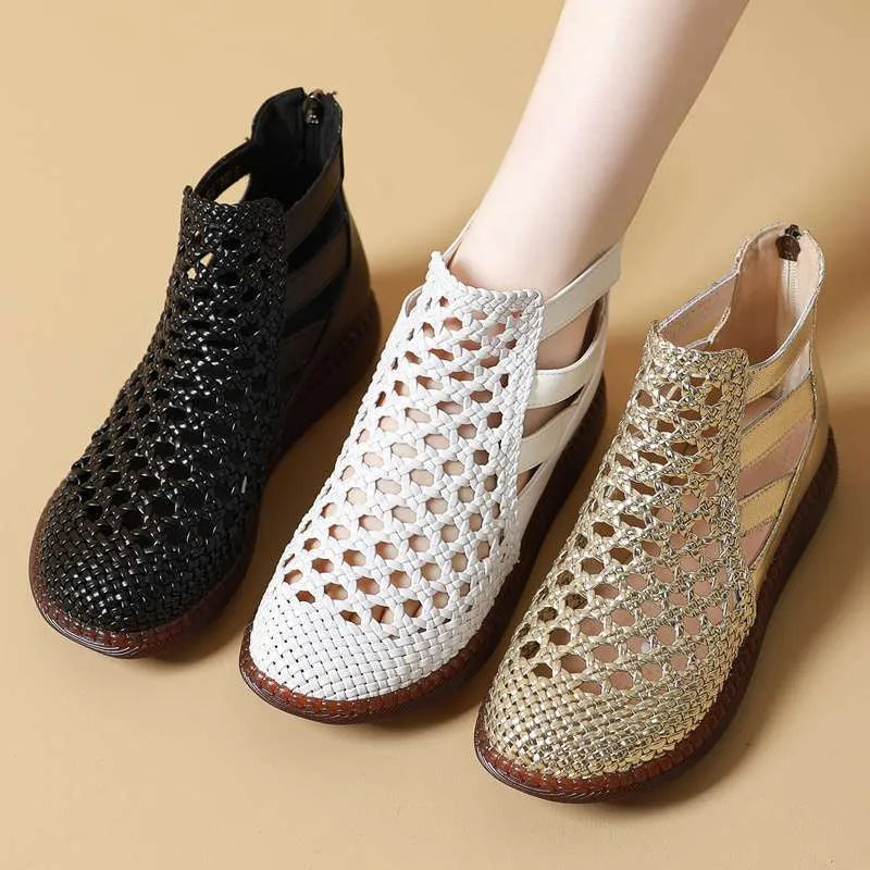 Gold flat sandals with round toe and breathable hollow-out design on a white background.