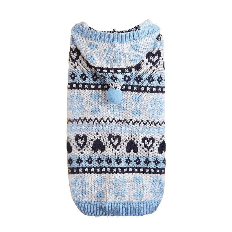 Blue knitted dog sweater with white snowflake and love heart patterns on a striped camouflage background.