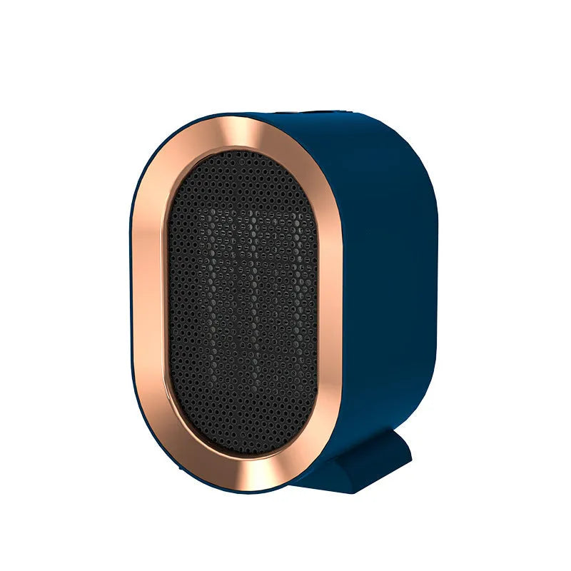 Compact desktop ceramic fan heater in black on a wooden desk.