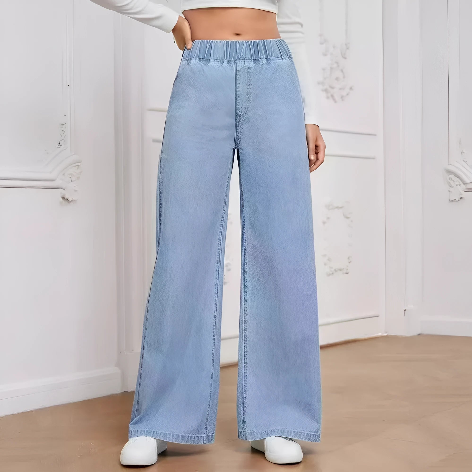 Plus size light blue washed denim trousers with a wide-leg straight cut and zip fly.