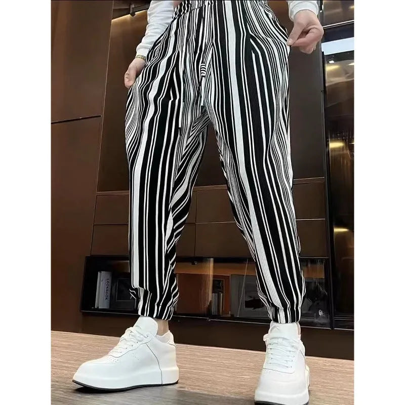 Men's cropped ankle-tied ice silk pants in dark gray stripe pattern, front view on model