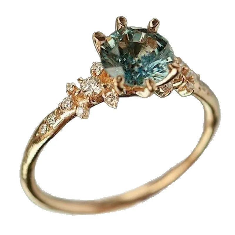 Gold plated geometric ring with claw inlaid zircon stone and chamfered square pattern.